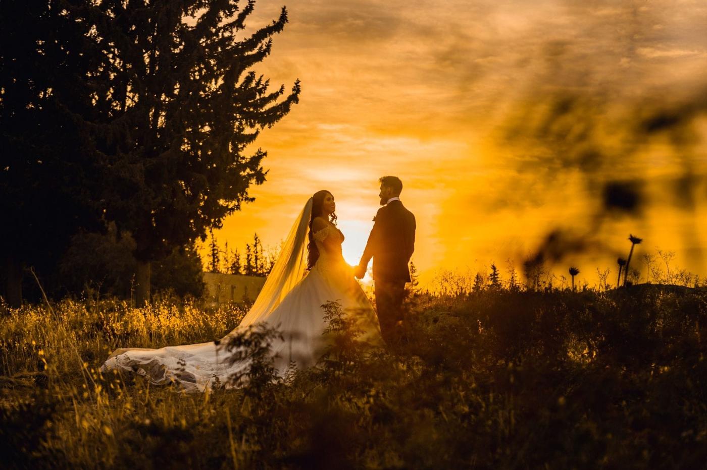 A couple holding hands at golden sunset