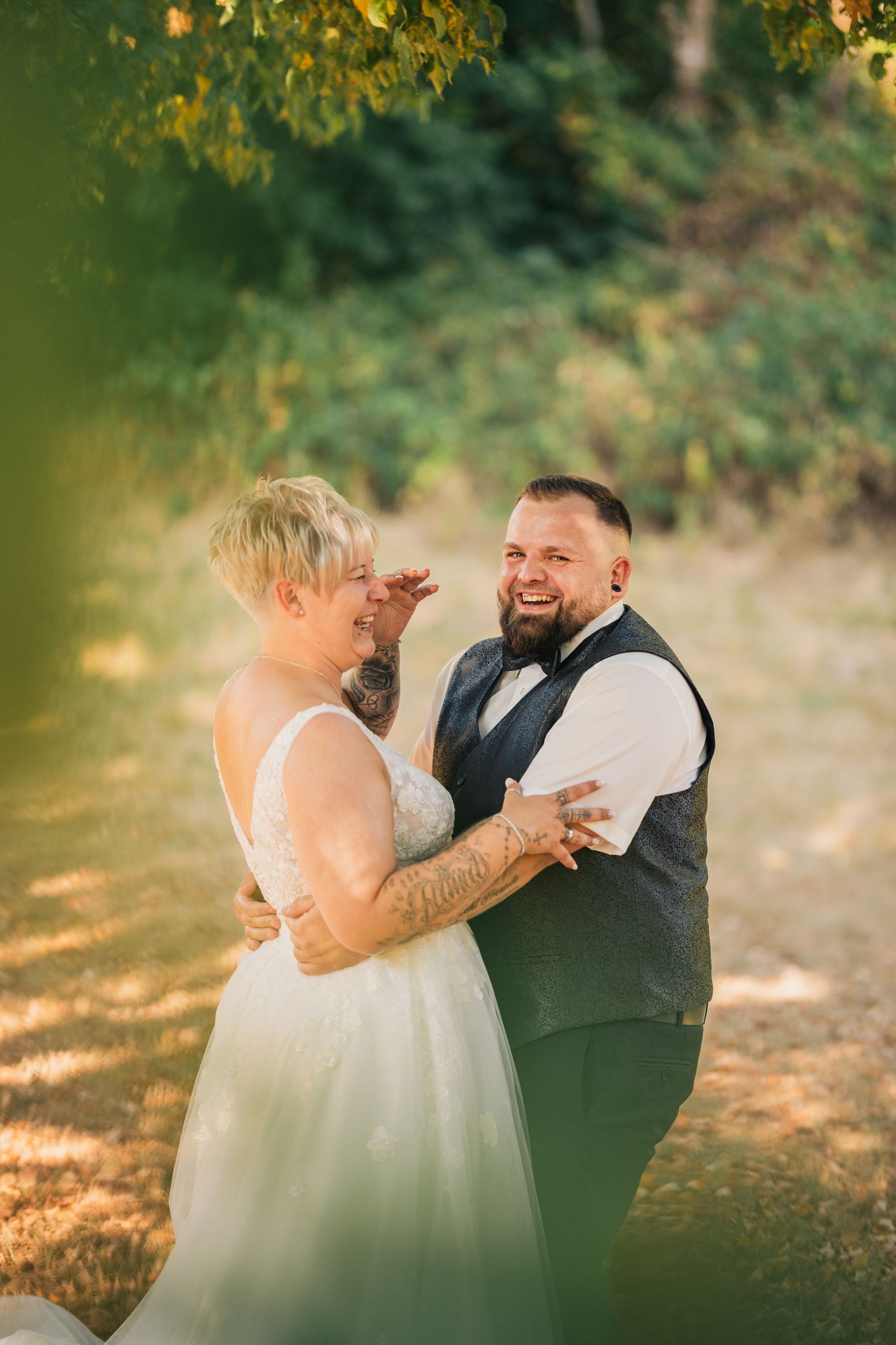Smiling newlywed couple in the park