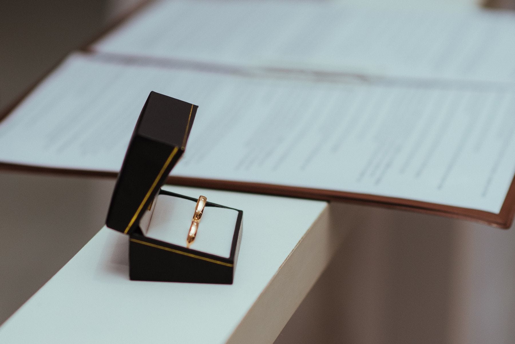 Elegant wedding rings in open box on table