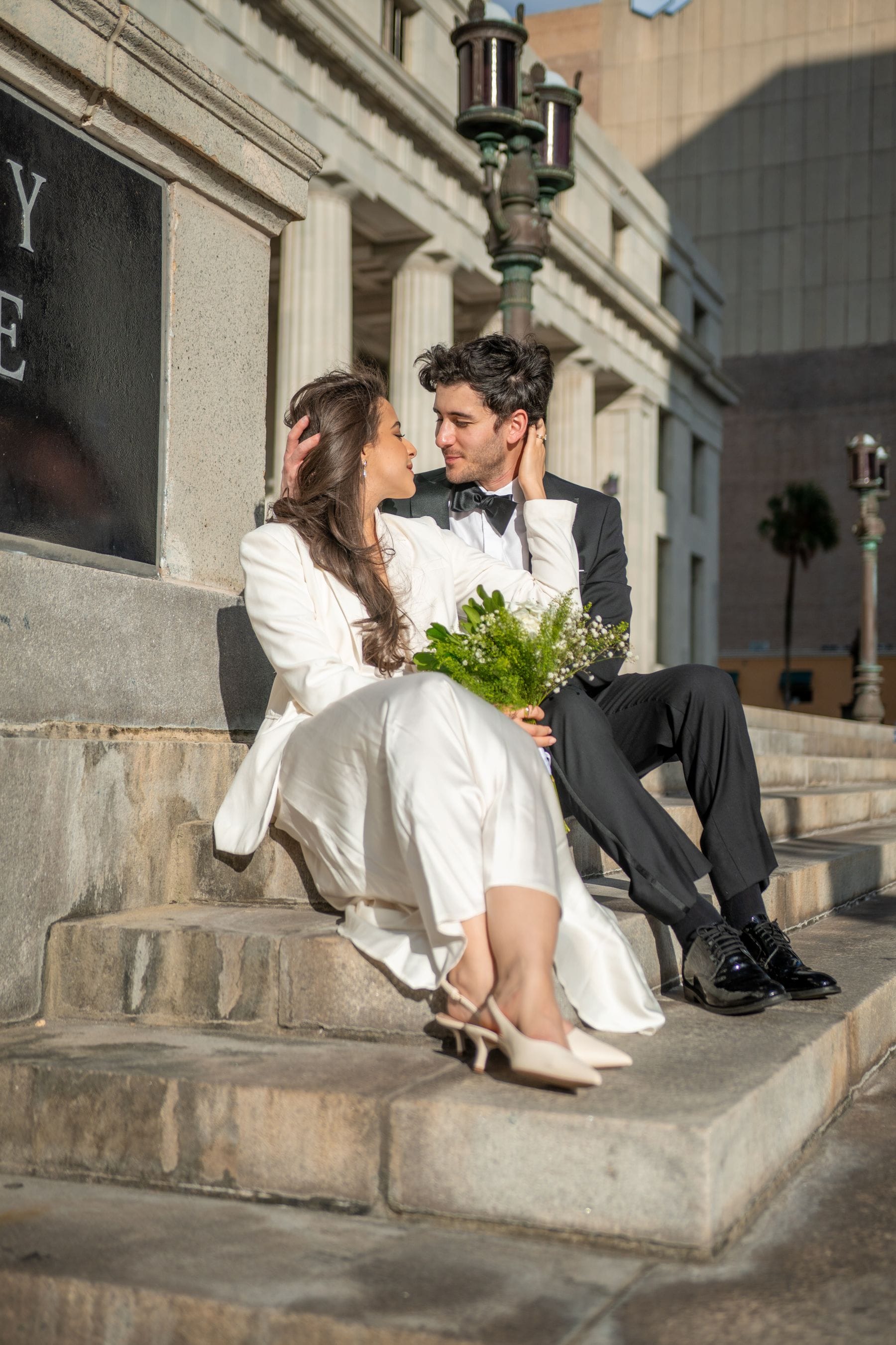Elegant urban wedding couple on stone steps