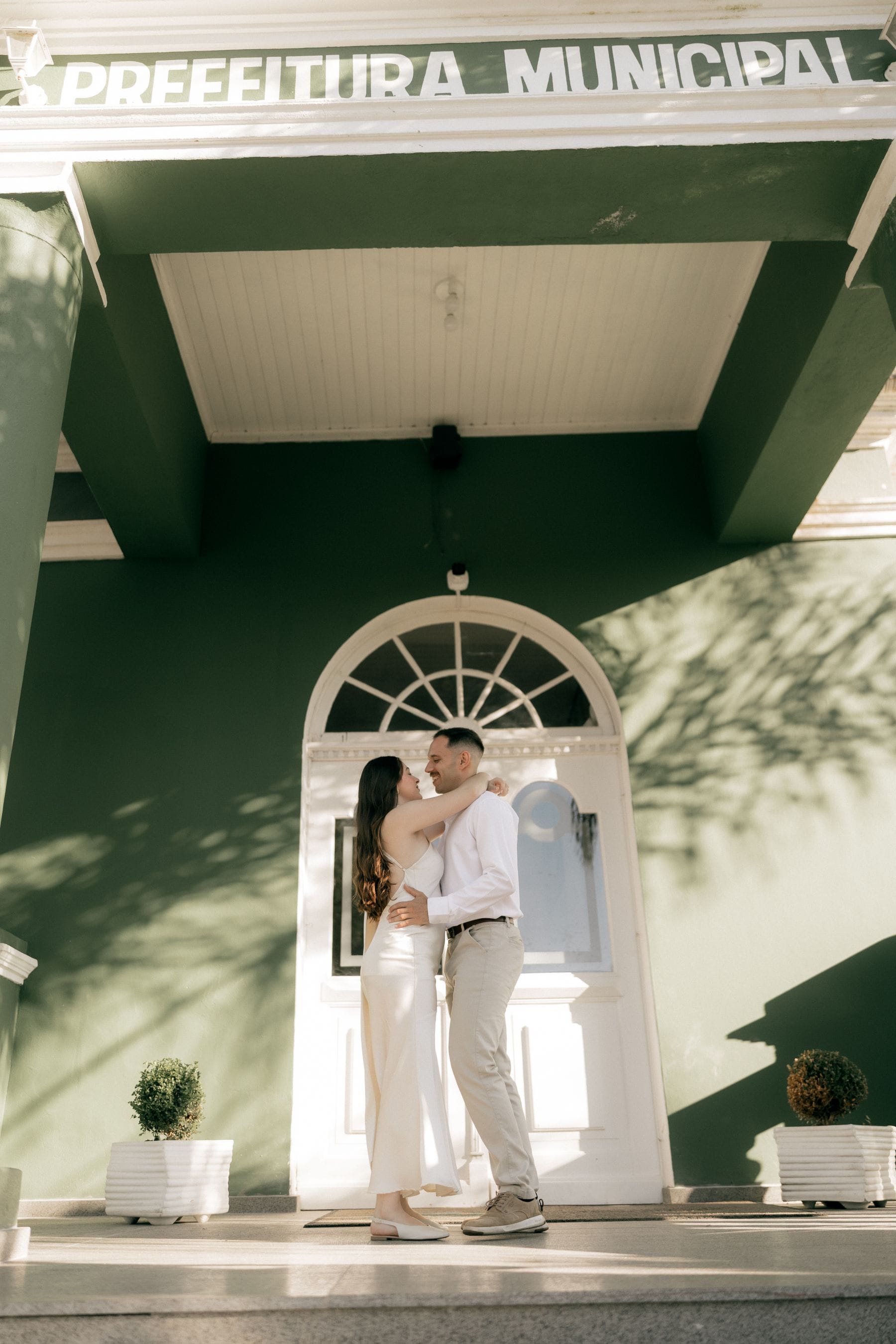 Romantic couple embracing outside a municipal building