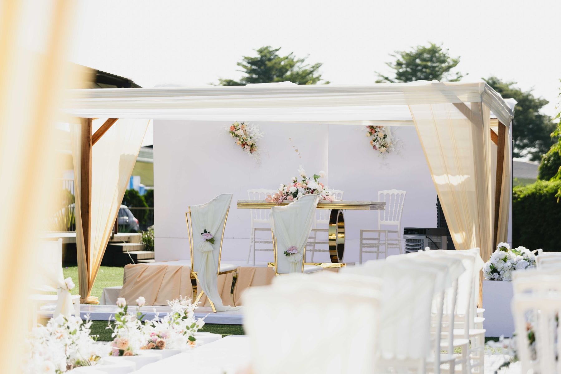 Elegant outdoor wedding ceremony setup with floral decor